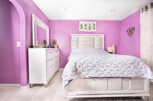 bedroom with light tile patterned floors