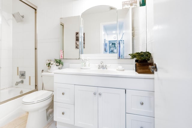 full bathroom featuring tile patterned flooring, vanity, toilet, and tiled shower / bath