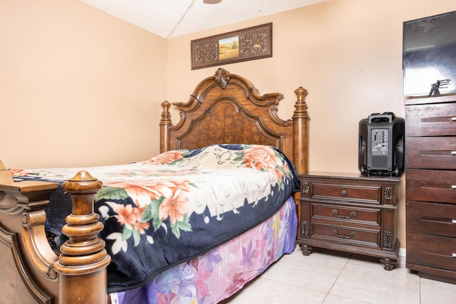 bedroom with light tile patterned flooring and a textured ceiling