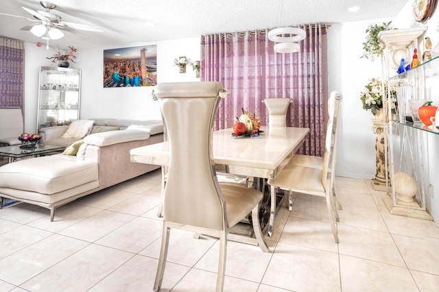 tiled dining area featuring ceiling fan and a textured ceiling