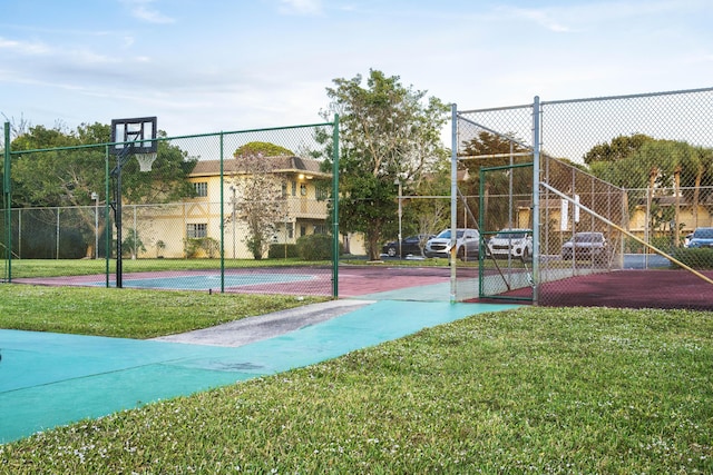 view of sport court with a lawn