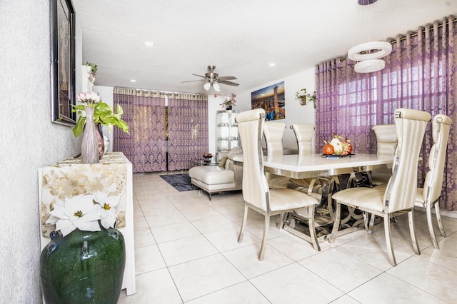 tiled dining space featuring ceiling fan