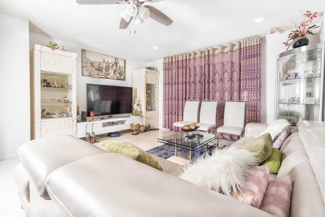 tiled living room with a textured ceiling and ceiling fan