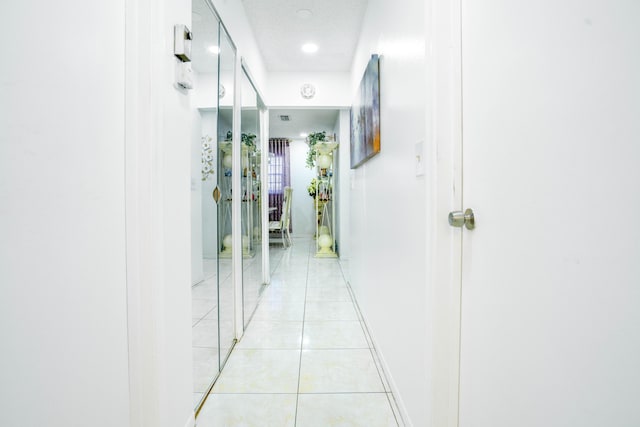 hallway with light tile patterned flooring