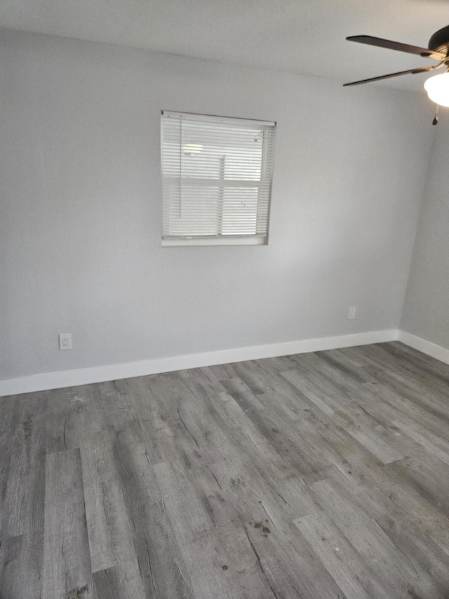 spare room with ceiling fan and light wood-type flooring