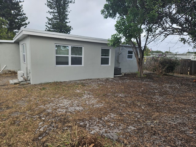 rear view of property with central air condition unit