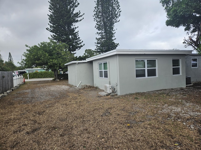 view of side of home featuring ac unit and central AC unit