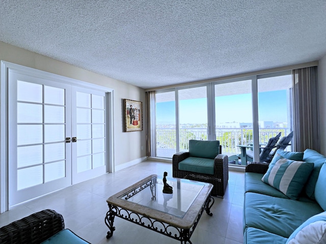 living room featuring a textured ceiling and a wall of windows