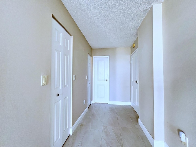 corridor with a textured ceiling