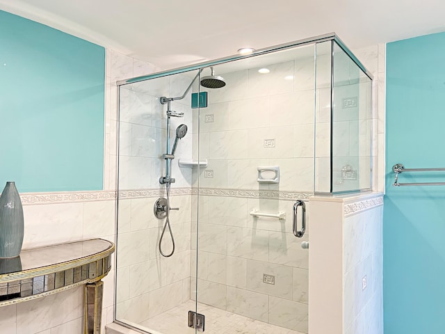 bathroom featuring a shower with door and tile walls