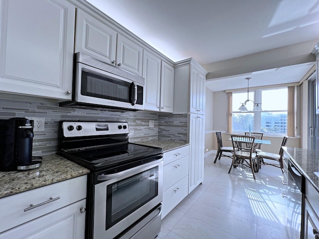 kitchen with light tile patterned floors, light stone counters, decorative backsplash, white cabinets, and appliances with stainless steel finishes