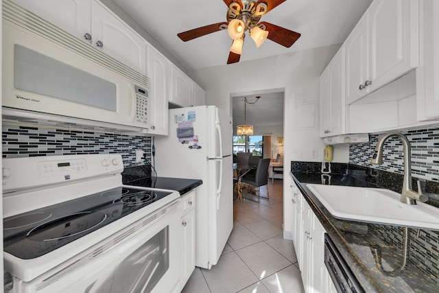 kitchen featuring sink, white appliances, white cabinetry, light tile patterned flooring, and ceiling fan with notable chandelier