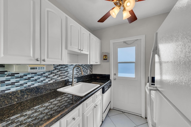 kitchen featuring white appliances, white cabinets, tasteful backsplash, sink, and light tile patterned flooring