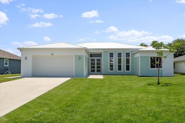 ranch-style home featuring a garage and a front lawn