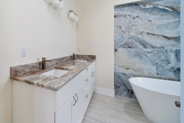 bathroom featuring a tub, tile patterned flooring, and vanity