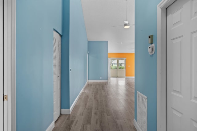 hallway with light hardwood / wood-style flooring