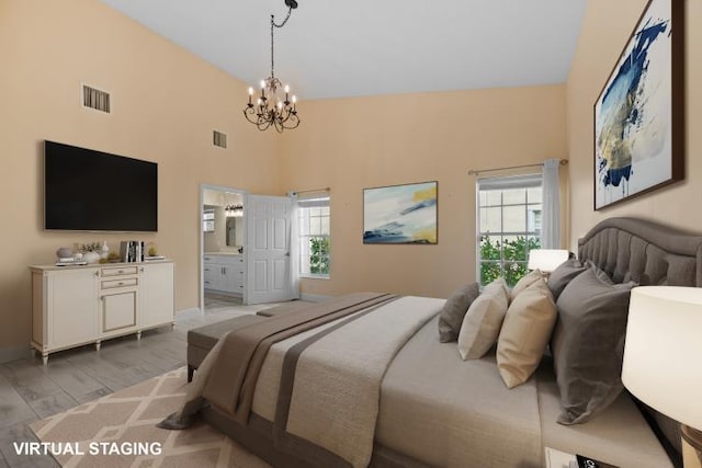 bedroom featuring ensuite bath, a notable chandelier, multiple windows, and light wood-type flooring