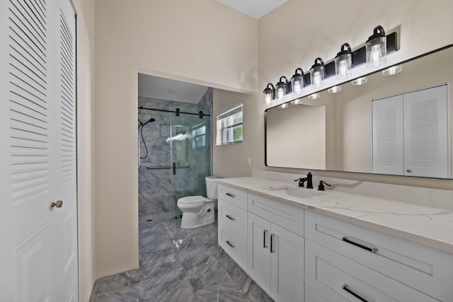 bathroom with vanity, tiled shower, and toilet