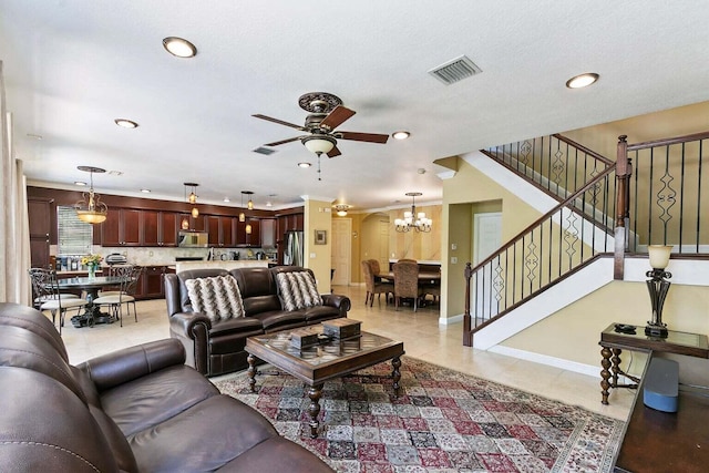 tiled living room featuring ceiling fan with notable chandelier