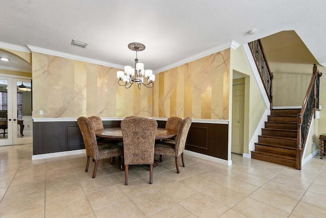 dining area with ornamental molding, light tile patterned floors, and an inviting chandelier