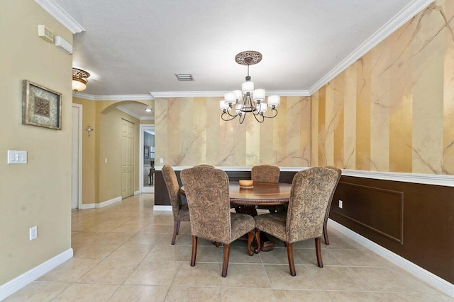 tiled dining room with an inviting chandelier and ornamental molding