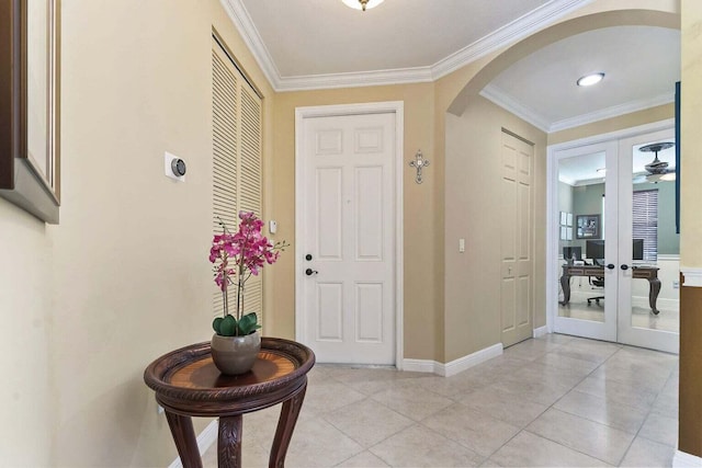 tiled foyer featuring french doors and crown molding