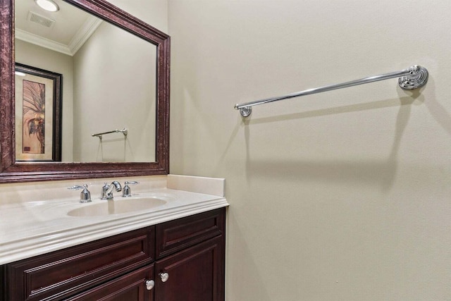 bathroom with crown molding and vanity