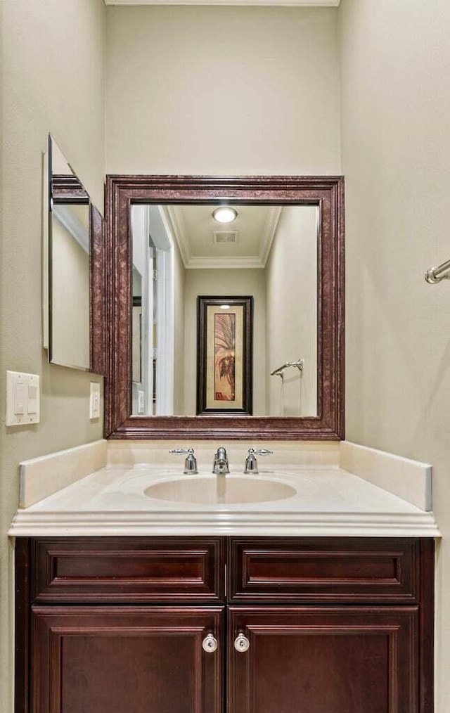 bathroom featuring crown molding and vanity