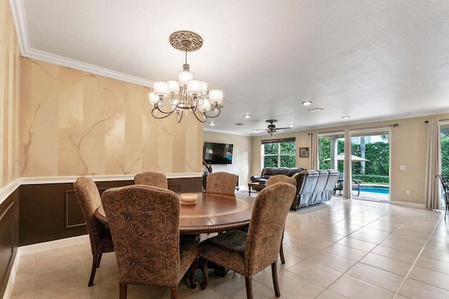 tiled dining space with ceiling fan with notable chandelier and crown molding