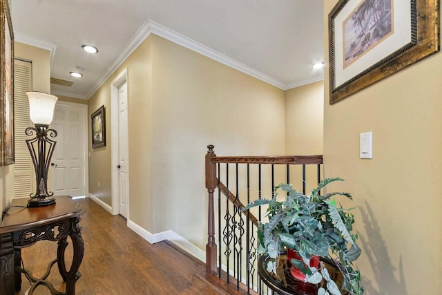 hall with dark wood-type flooring and crown molding