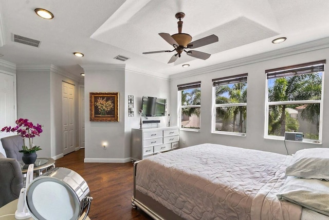 bedroom featuring a closet, crown molding, ceiling fan, and dark wood-type flooring