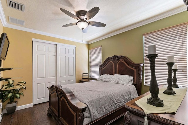 bedroom with dark hardwood / wood-style flooring, ceiling fan, a closet, and crown molding