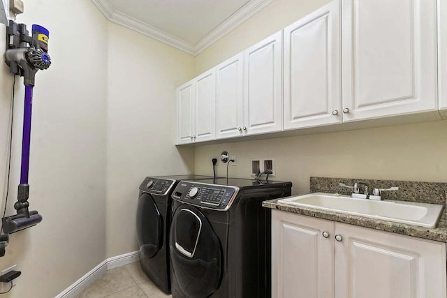 washroom featuring cabinets, ornamental molding, sink, light tile patterned floors, and washing machine and dryer