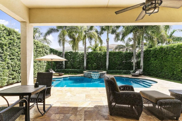 view of swimming pool featuring an in ground hot tub and a patio area