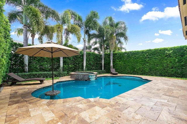 view of pool with a patio area and an in ground hot tub