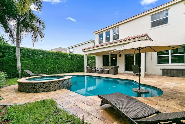 view of pool featuring an outdoor living space, an in ground hot tub, and a patio