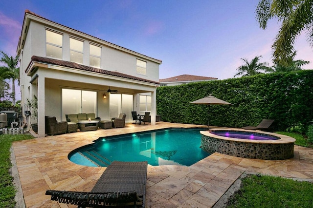 pool at dusk with ceiling fan, central AC, an outdoor hangout area, an in ground hot tub, and a patio