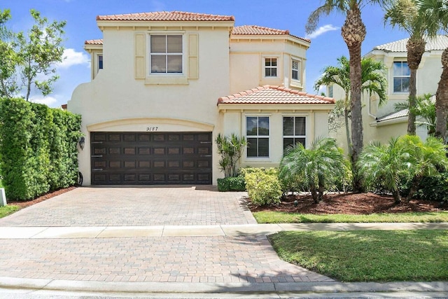 mediterranean / spanish-style house with a garage