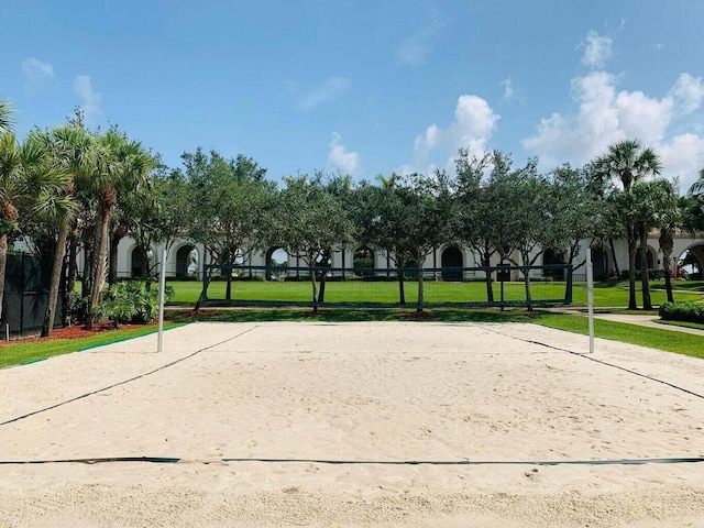 view of home's community featuring a lawn and volleyball court