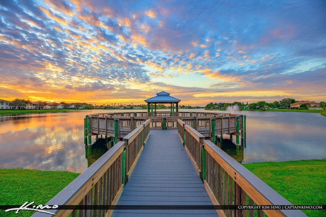 view of dock featuring a gazebo and a water view