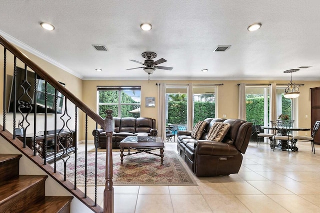 tiled living room with ceiling fan and a textured ceiling