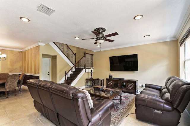 living room with a textured ceiling, crown molding, light tile patterned flooring, and ceiling fan with notable chandelier