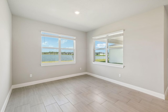 spare room featuring a water view