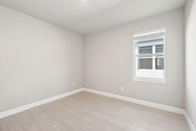 empty room with light hardwood / wood-style floors