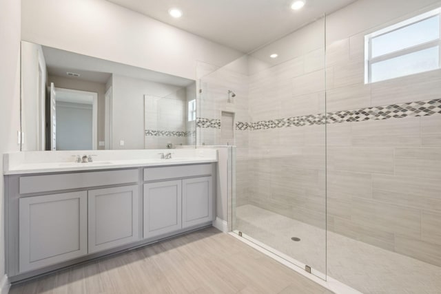 bathroom with vanity and tiled shower