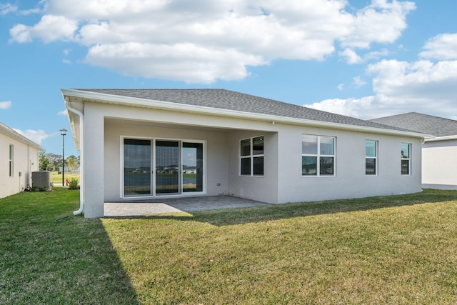 back of property featuring central AC, a patio, and a lawn