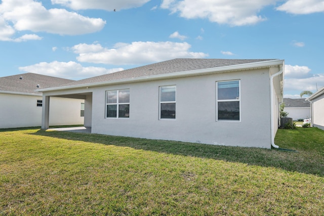 rear view of property featuring a lawn