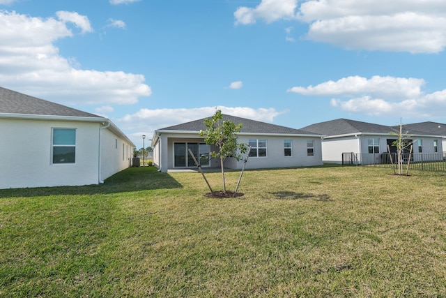 rear view of house with a lawn