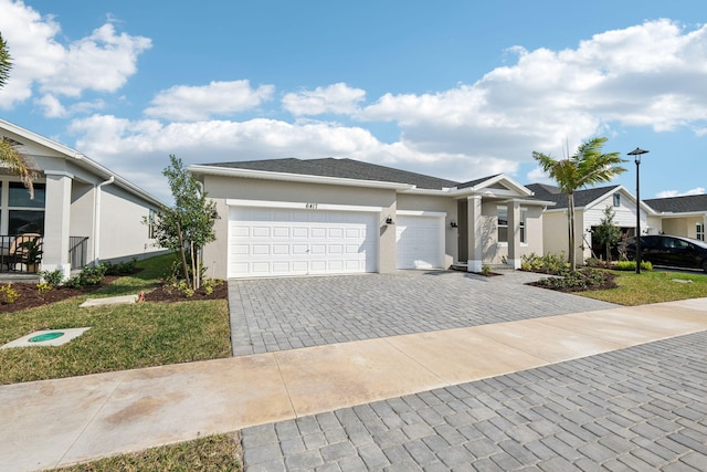 view of front of home featuring a garage and a front lawn