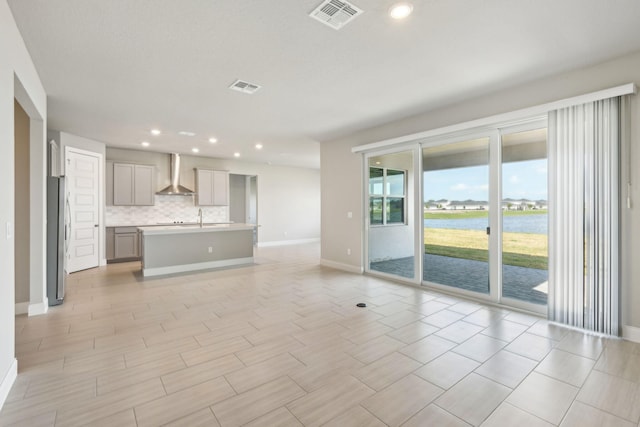 unfurnished living room with sink